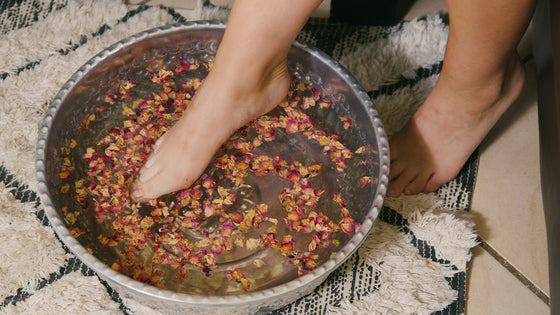 A foot resting in a warm soak with Kunzea Bath Salts